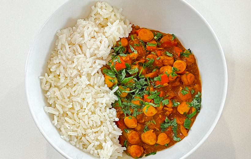 North Indian Chickpea Chole made with the Indian "Holy Chole" spice blend. served in a bowl with white rice on the side.