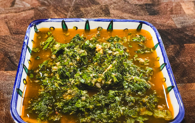 a small dish with fresh, bright homemade chimichurri sauce.